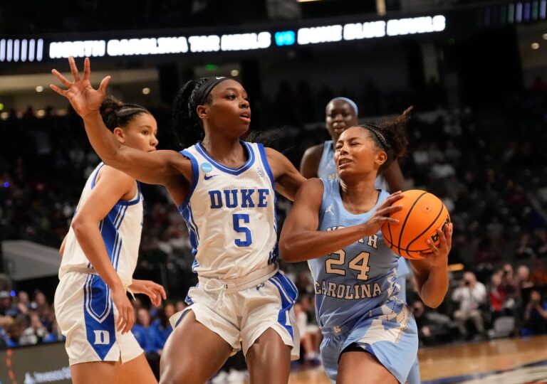 Duke Blue Devils guard Oluchi Okananwa (5) defends a drive by North Carolina Tar Heels guard Indya Nivar (24) at Legacy Arena in the Sweet 16. Duke advanced to the Elite 8 with a 47-38 victory.