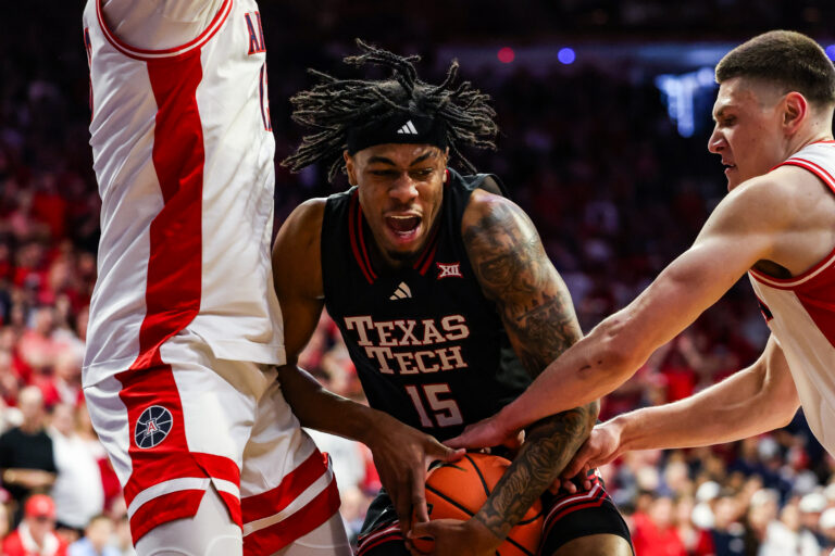 Arizona Wildcats forward Ivan Kharchenkov (8) attempts to steal the ball from Texas Tech Red Raiders forward JT Toppin (15) during the first half of the game at McKale Memorial Center.