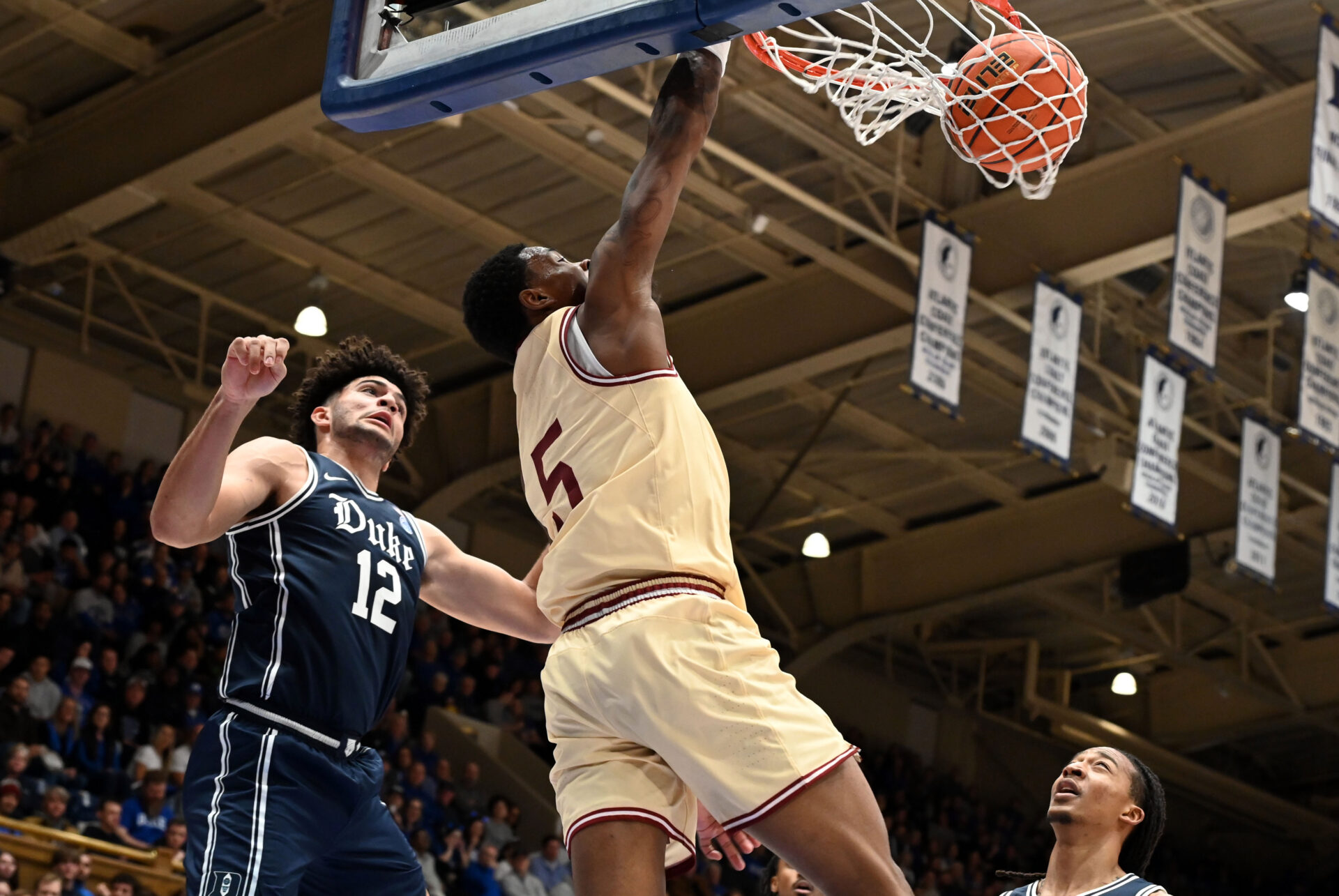 Boston College Eagles guard Fred Payne (5) dunks in front of Duke Blue Devils forward Cameron Boozer (12) during the first half at Cameron Indoor Stadium.