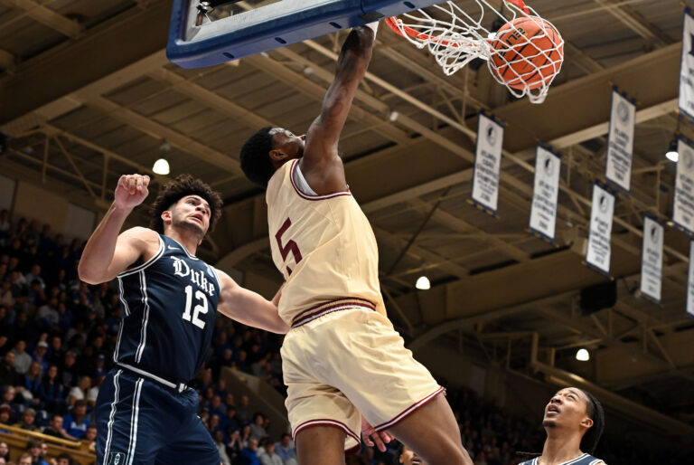 Boston College Eagles guard Fred Payne (5) dunks in front of Duke Blue Devils forward Cameron Boozer (12) during the first half at Cameron Indoor Stadium.