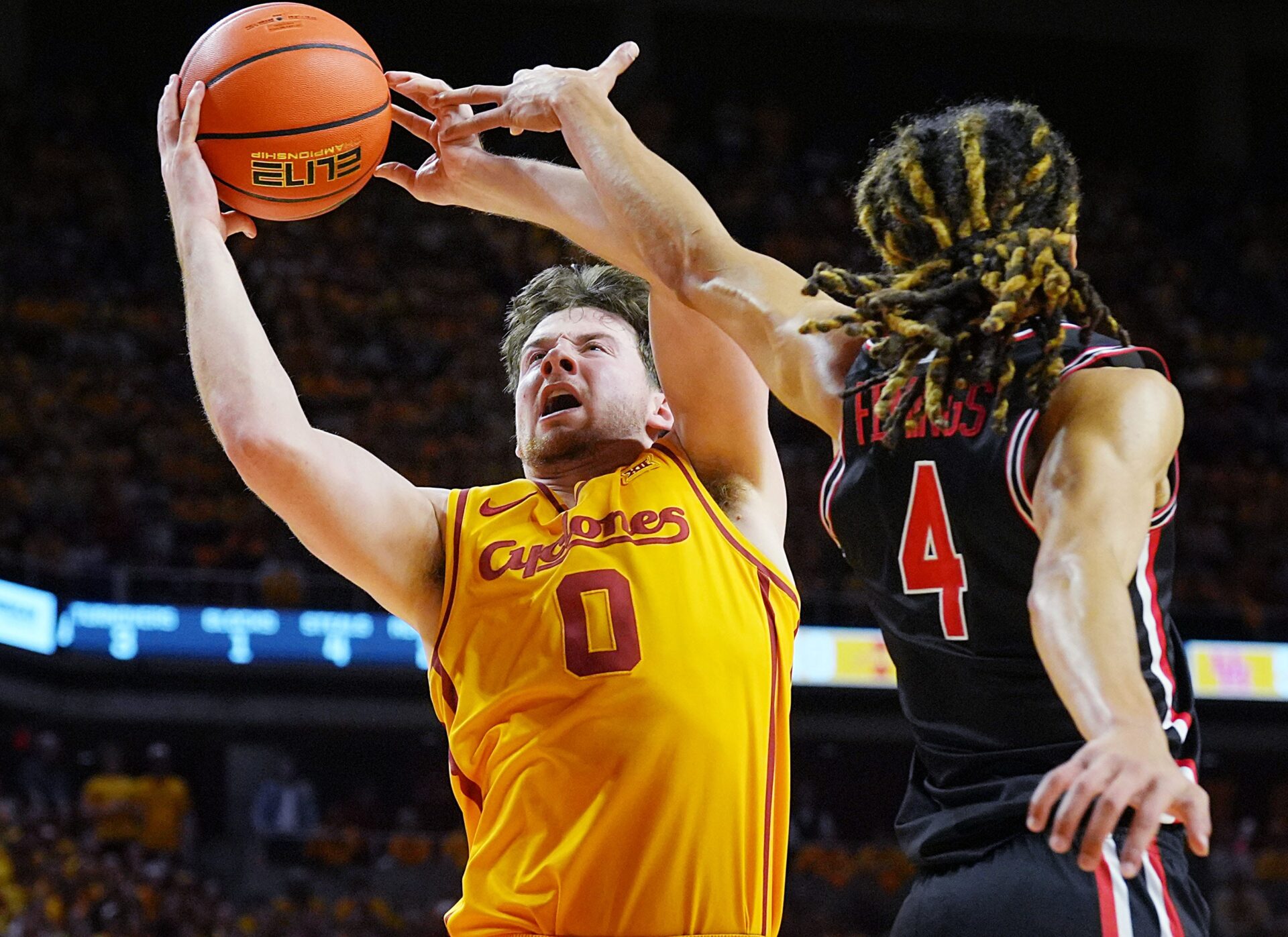 Iowa State Cyclones guard Nate Heise (0) goes for a layup around Houston Cougars guard Kingston Flemings (4) during the second half in the Big-12 men’s basketball at Hilton Coliseum on Feb. 16, 2026, in Ames, Iowa