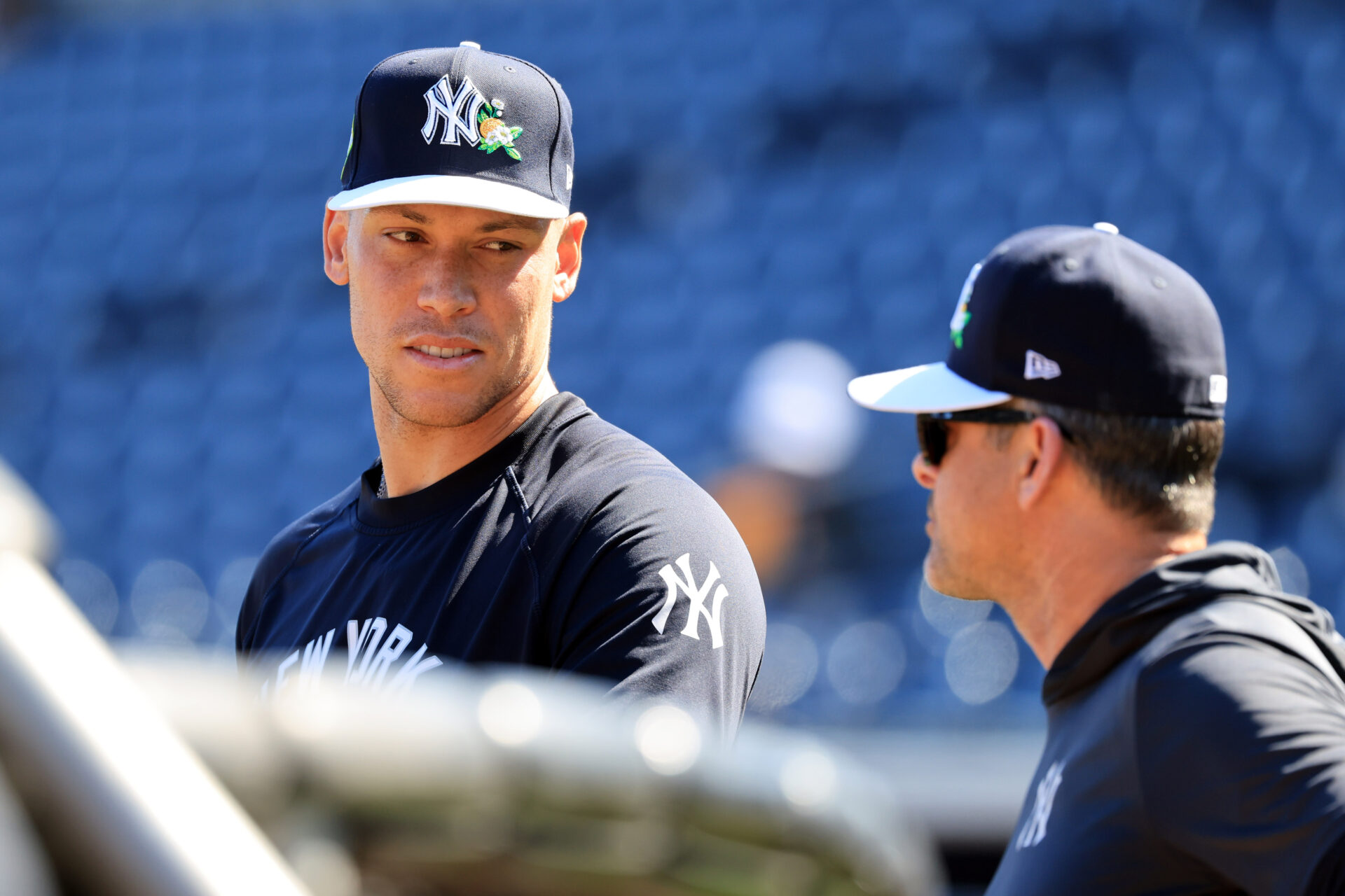 New York Yankees right fielder Aaron Judge (99) and manager Aaron Boone (17) talk uring spring training practices at George M. Steinbrenner Field.