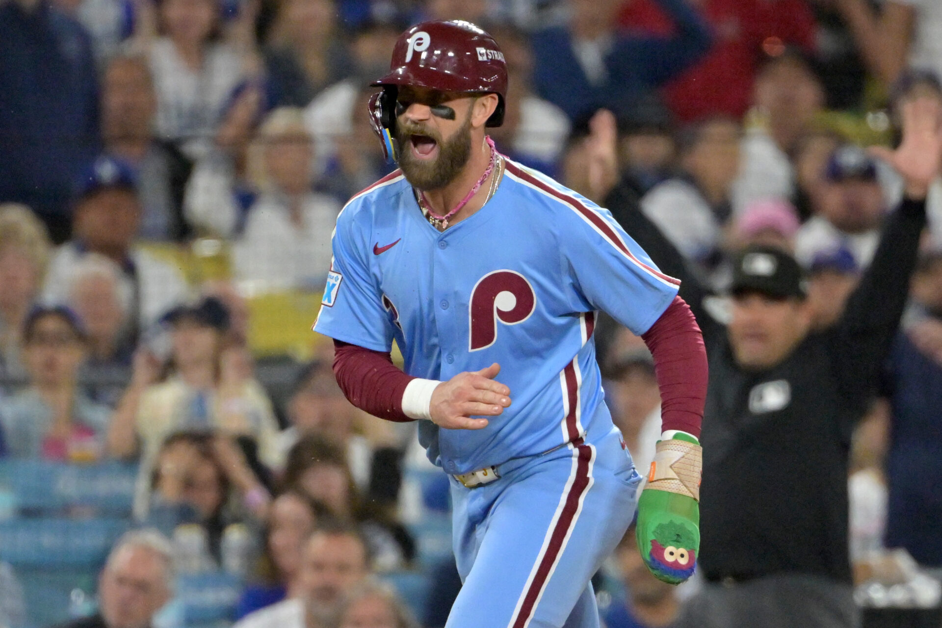 Philadelphia Phillies first baseman Bryce Harper (3) reacts as he scores a run during the fourth inning in game three of the NLDS against the Los Angeles Dodgers during the 2025 MLB playoffs at Dodger Stadium.