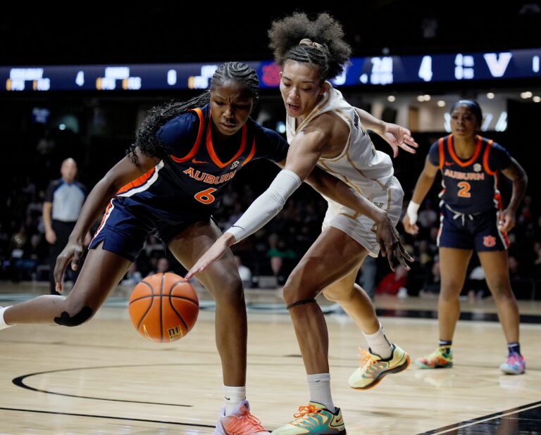 Vanderbilt guard Ndjakalenga Mwenentanda (15) reaches in knocking the ball away from Auburn forward Khady Leye (6) during the first half of an NCAA college basketball game at Memorial Gymnasium Thursday, Jan. 22, 2026, in Nashville, Tenn.