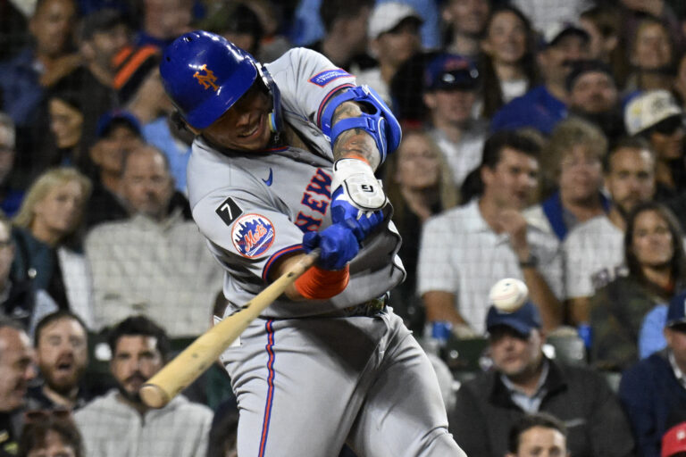 New York Mets catcher Francisco Alvarez (4) hits a two run home run against the Chicago Cubs during the fifth inning at Wrigley Field.