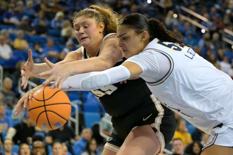 Purdue Boilermakers forward Avery Gordon (55) and UCLA Bruins center Lauren Betts (51) reach for a loose ball in the second half at Pauley Pavilion presented by Wescom Financial.