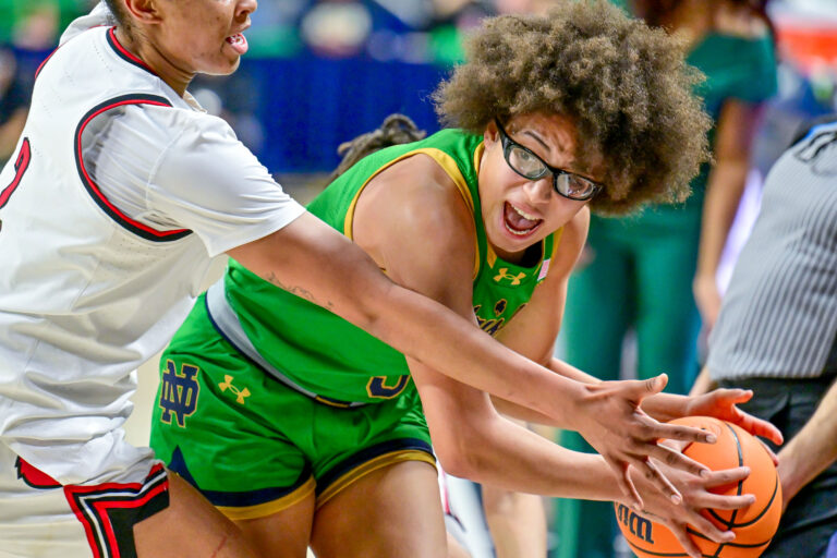 Notre Dame Fighting Irish guard Olivia Miles (5) looks to pass as Louisville Cardinals forward Nyla Harris (2) defends in the second half at the Purcell Pavilion.