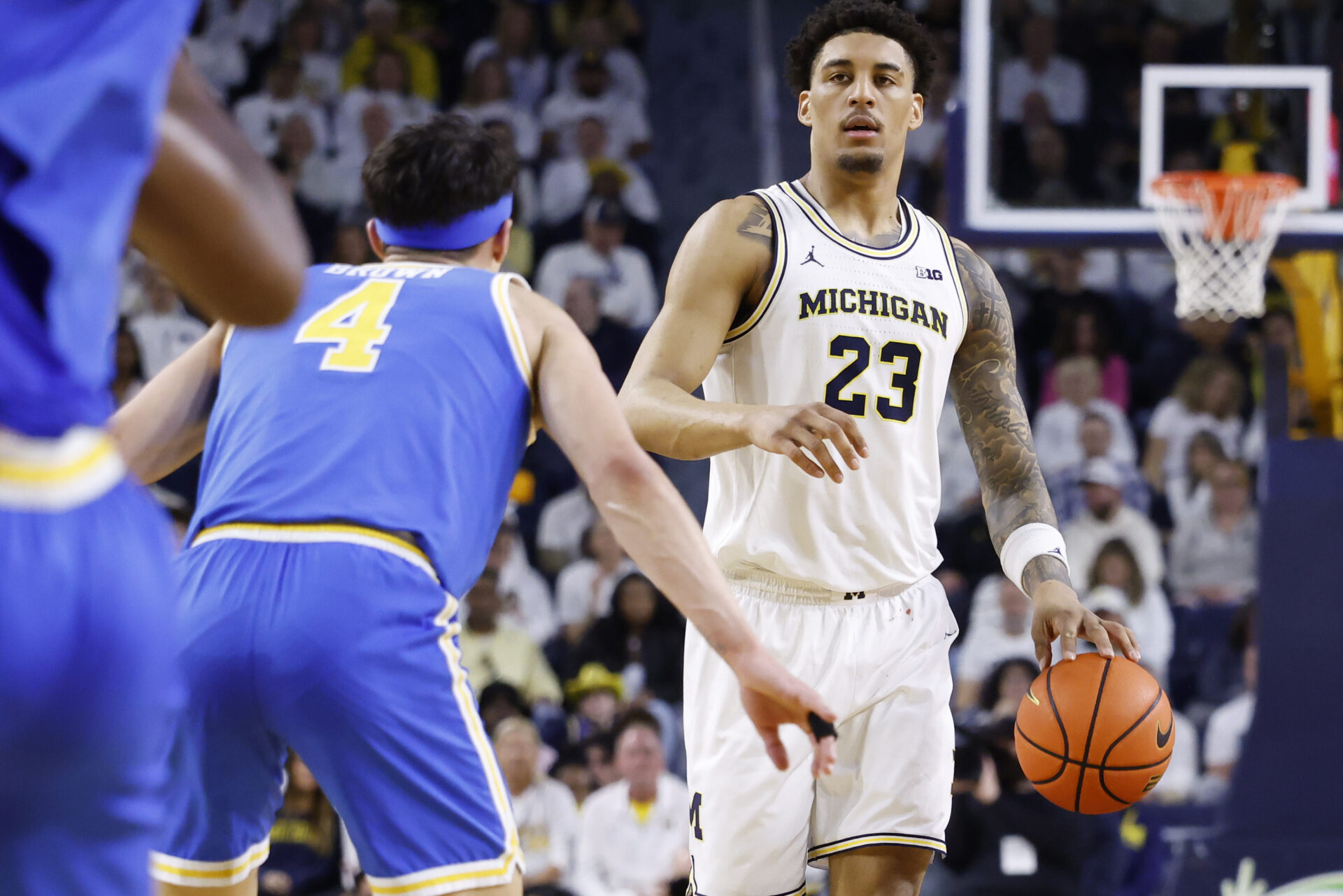 Michigan Wolverines forward Yaxel Lendeborg (23) is defended by UCLA Bruins guard Jamar Brown (4) in the first half at Crisler Center.